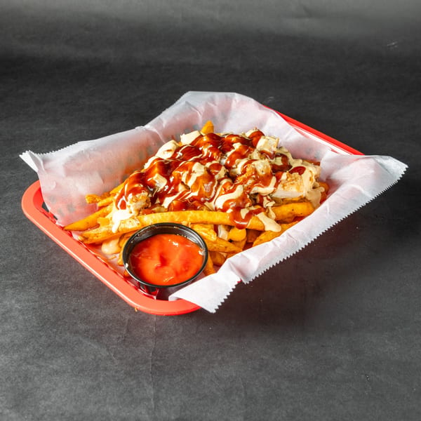 Stack'd Burger's poutine with fries, cheese curds, gravy, and a side of ketchup.